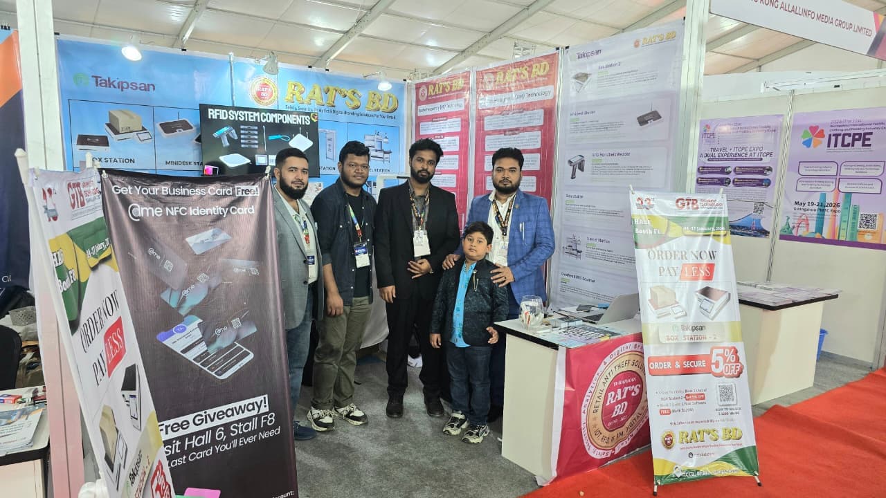 Four members of the RATS BD team and a child standing at the company's trade-fair booth, in front of printed RAT'S BD and Takipsan banners and an RFID system components poster